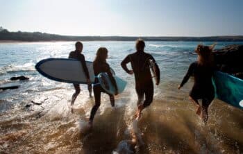 Four people going surfing in Cornwall